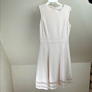 Calvin Klein Fit and Flair dress. Pale Pink. Size 8. Cute Peek-a-boo hemline.